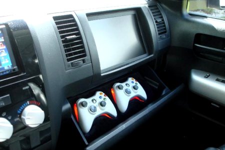 11" in-dash screen with suede upholstered game controller storage.