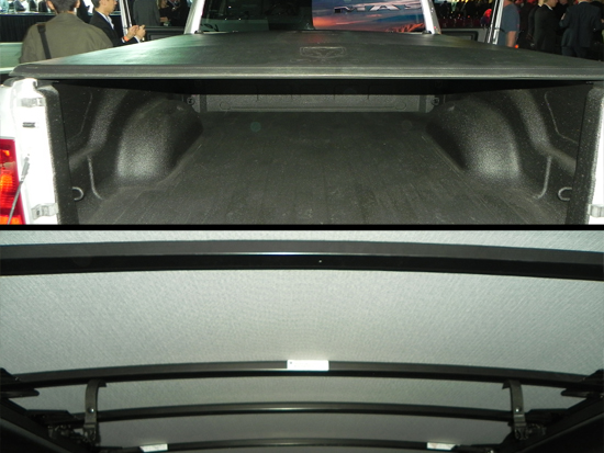 Its hard to photograph, but this isn't your standard tonneau cover. It has a "hump" like a tent in the middle of the cover. It drops toward the cab and on the back plus off the sides. If you look closely at the bars, you can see this slight rise. 